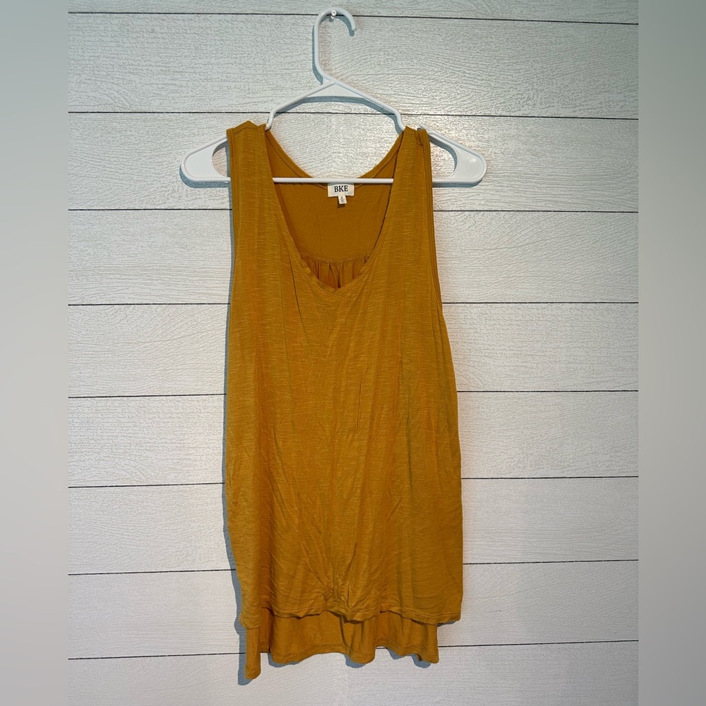 Mustard, yellow tank top, size small, lightly used. In great condition.